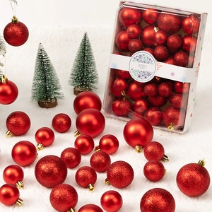 Detail of red Christmas balls with matte, glossy, and glitter finishes in a gift box