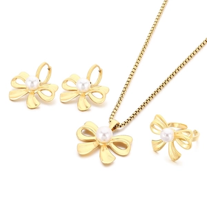 Elegant gold-tone stainless steel jewelry set with bow design and white pearls