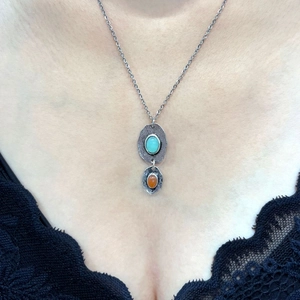 Bohemian double layered pendant necklace with turquoise and orange stones on a model