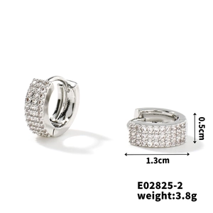 Detail shot of micro-pave cubic zirconia silver hoop earrings measuring 1.3cm x 0.5cm