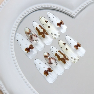 Handmade brown cat eye press-on nails with leopard print, polka dots, and 3D bows