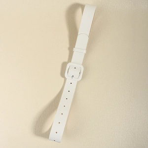 Detail view of white leather belt with a square buckle and adjustable pin holes