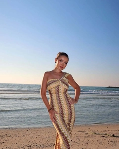 Detailed pattern of a one-shoulder printed lace beach maxi dress in warm wave colors