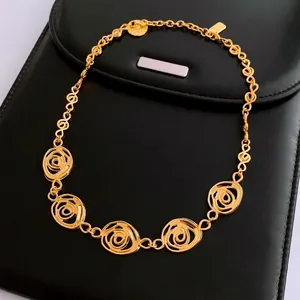 Vintage French floral hollow gold necklace set displayed on high-quality black leather