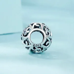 Hollow S925 sterling silver charm with intricate vine patterns and blue zircon stones