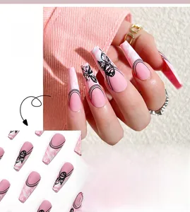 Detailed view of nude pink ballet press-on nails with black butterfly and French line art