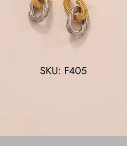 Macro shot of two-tone gold and silver interlocking textured metal link earrings