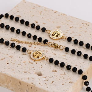Elegante collana albero della vita in perle di vetro nere con catena d'oro e strass