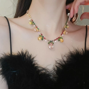 Detail of zircon flower necklace with colorful crystals and pink teardrop pendant