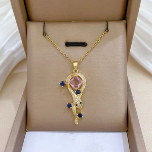 Close-up of snake snake-themed necklace with pink gemstone and zircon in a jewelry box