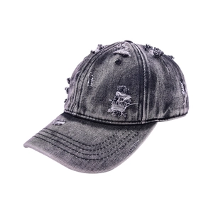 Distressed vintage washed denim baseball cap with ripped details and worn-out street style