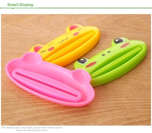 Detail of colorful animal-shaped toothpaste squeezers on a wooden surface background