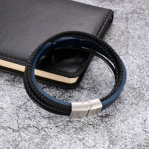Detail of multi-layer braided leather bracelet with blue and black textures and metal clasp