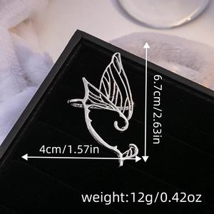Close-up of silver butterfly wing ear cuff with dimensions 6.7cm by 4cm on black velvet