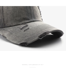 Detailed macro view of distressed dark grey cotton baseball cap with vintage frayed edges