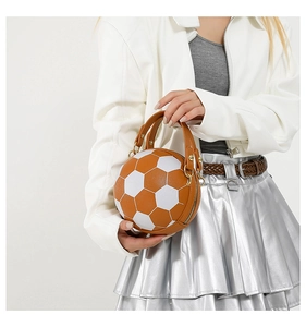 Detail shot of a soccer-shaped crossbody bag featuring premium PU patchwork and metal zipper