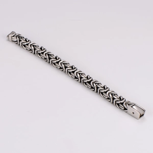 Detailed view of men's Byzantine woven stainless steel bracelet with vintage silver finish