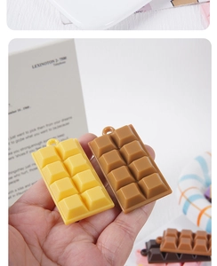 Macro detail of mini 3x2 chocolate block pendants in yellow and brown resin with hanging holes