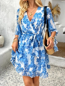 Detail of floral print V-neck wrap dress with tie waist and ruffled hem for summer vacation