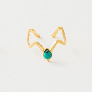 Detail of vintage gold wave bangle featuring a teardrop turquoise gemstone and dot relief