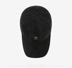 Detailed top view of a dark wool baseball cap with a gold metal C letter logo