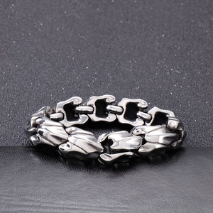 Macro detail of industrial style stainless steel dragon bone link bracelet for men