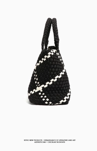 Detailed view of the black and white woven texture on a large capacity tote bag