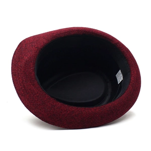 Detailed interior view of burgundy fedora hat showing 58cm size label and fabric texture