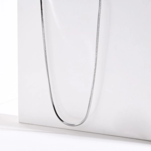Detail of silver square snake bone chain necklace with smooth polished stainless steel finish