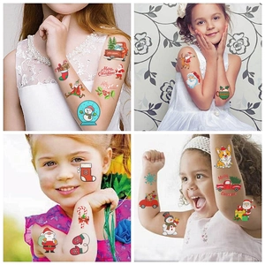Detail of colorful Christmas temporary tattoos on child arm featuring Santa and snowman