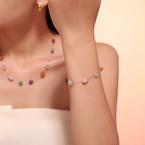 Detailed view of bohemian colorful crushed stone necklace and bracelet jewelry set on model