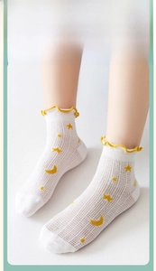 Detail of breathable mesh cotton socks with yellow moon stars and ruffled lettuce edge