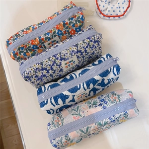 Detail view of floral and animal print canvas pencil cases with zipper closure