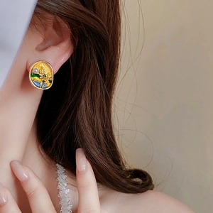 Vintage oval enamel stud earrings with wheat motif and pearl on a female model