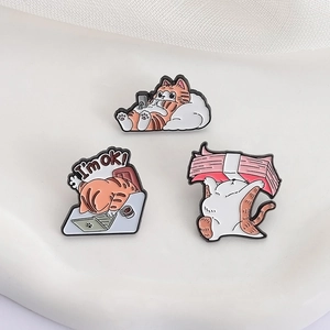 Set of cute orange cartoon cat enamel pins in various poses made of metal for badges