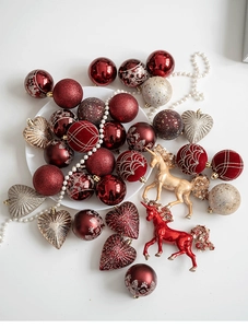 Detail of red and gold glitter Christmas ornaments including unicorn and heart shapes
