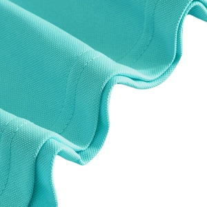 Close-up of turquoise pique polo shirt fabric showing breathable honeycomb texture