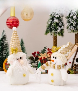 Detailed view of plush Christmas gnome and snowman doll set with gold sequined hats