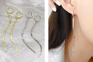 Detail of long snake chain tassel earrings in gold and silver finish on model and flat lay