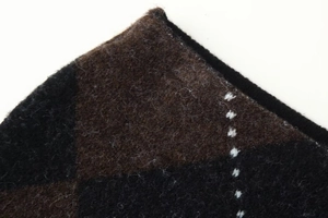Close-up of soft argyle knit fabric with fuzzy texture and high-quality needlework detail