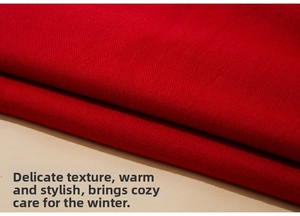 Close-up of red cashmere scarf showing detailed twill texture and soft fabric folds
