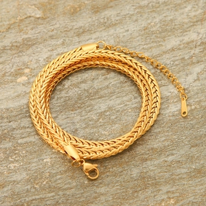 Close-up of golden braided stainless steel chain with lobster clasp and S.Steel tag