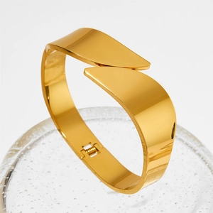 Minimalist gold-plated wide bypass bangle with polished finish and hinge closure