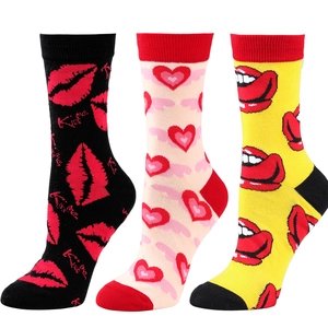 Detailed view of three mid-calf cotton socks with heart and lip patterns in various colors