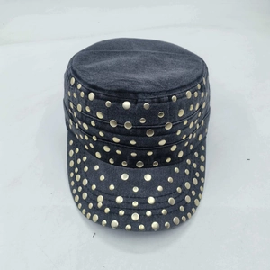 Close-up of dark grey washed denim military cap with golden metal rivets detailing
