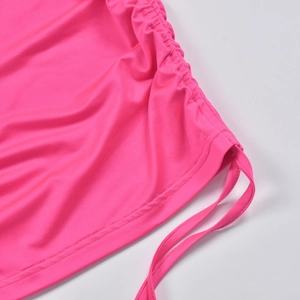 Detail of pink summer two-piece set featuring side drawstring and gathered pleats