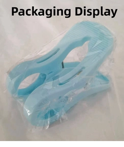 Detail view of large blue windproof plastic quilt clip in clear packaging for laundry