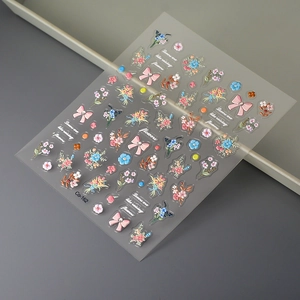 Detail of 5D floral nail stickers with pink rhinestone bows and dewdrop accents