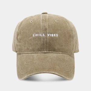 Detail of Chill Vibes embroidery on vintage washed cotton baseball cap in light khaki