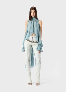 Detail of light blue chiffon top featuring high neck ruffles and back tie-up design